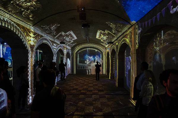 [photo] Lights projected unto the ceiling, walls, and pillars of cathedral-style room